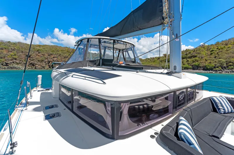 Slide: The Image of 2017 Lagoon 450 F catamaran on turquoise waters, featuring sleek design and spacious deck. - 14