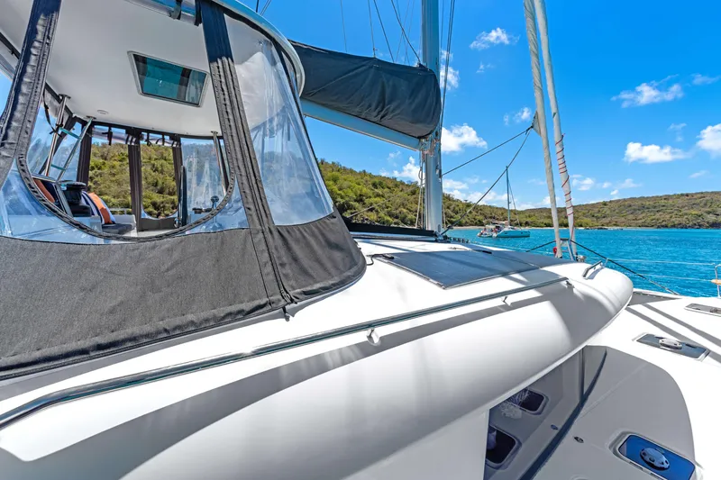 Slide: The Image of 2017 Lagoon 450 F catamaran on clear blue water, featuring sleek design and spacious deck. - 15