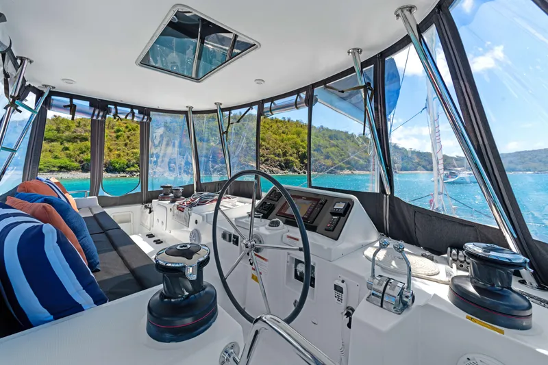 Slide: The Image of Interior view of 2017 Lagoon 450 F catamaran cockpit with scenic ocean backdrop. - 19