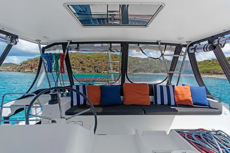 Slide: The Image of Cockpit of 2017 Lagoon 450 F catamaran with colorful cushions and scenic ocean view. - 20