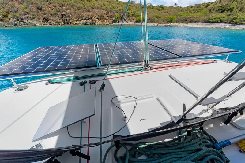 Slide: The Image of Lagoon 450 F catamaran with solar panels, anchored in a serene bay, 2017 model. - 21
