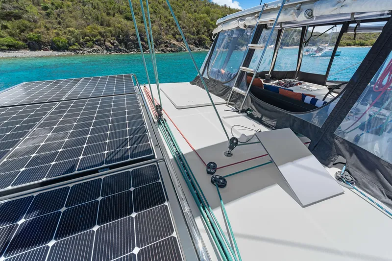 Slide: The Image of Catamaran Lagoon 450 F 2017 with solar panels, anchored in clear turquoise waters. - 23