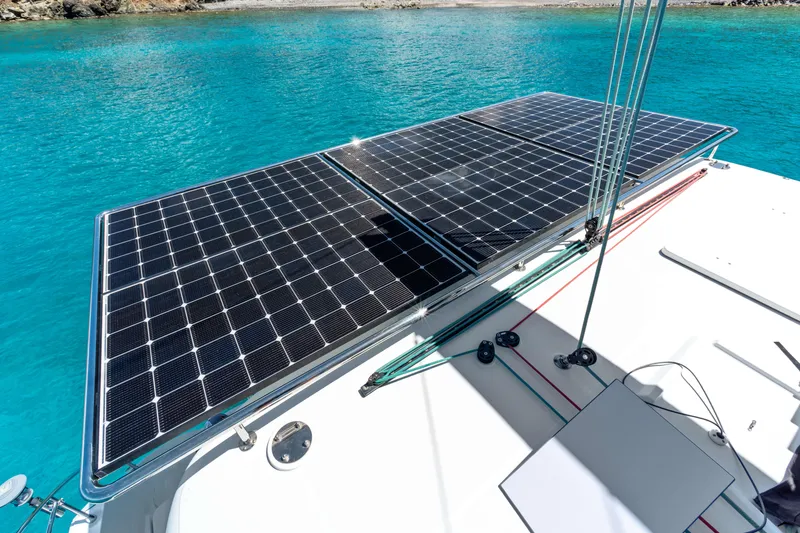 Slide: The Image of Solar panels on a 2017 Lagoon 450 F catamaran in clear blue waters. - 24