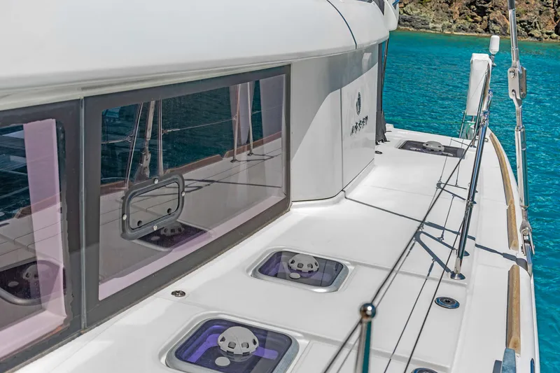 Slide: The Image of Lagoon 450 F catamaran, 2017 model, docked in clear turquoise waters. - 34