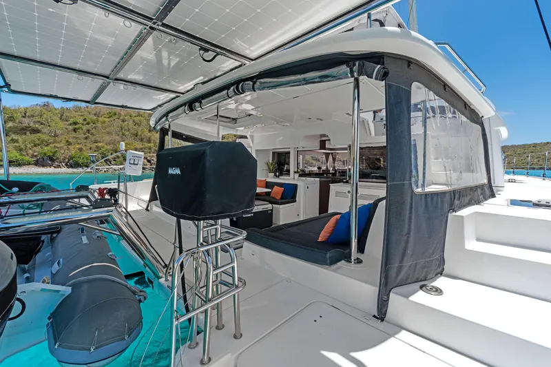 Slide: The Image of 2017 Lagoon 450 F catamaran with spacious deck, modern seating, and scenic ocean backdrop. - 37
