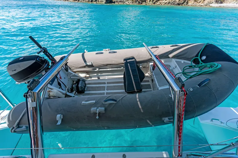 Slide: The Image of Inflatable dinghy on Lagoon 450 F yacht, 2017 model, in clear turquoise water. - 47