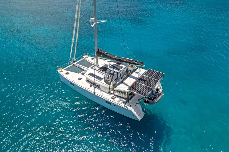 Slide: The Image of 2017 Lagoon 450 F catamaran with solar panels on turquoise water. - 6