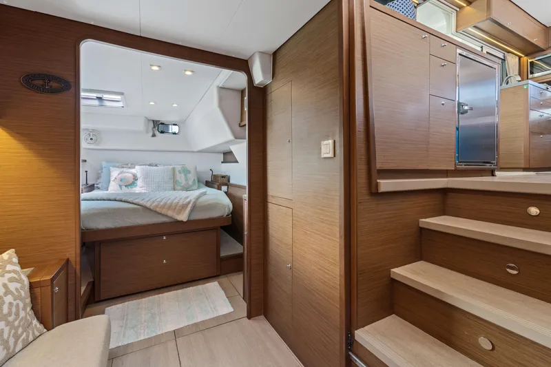 Slide: The Image of Interior of 2017 Lagoon 450 F yacht with cozy bedroom and wooden cabinetry. - 60