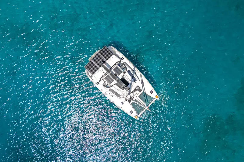 Slide: The Image of Aerial view of 2017 Lagoon 450 F catamaran on clear blue water. - 7