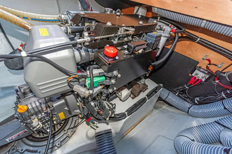 Slide: The Image of Engine compartment of a 2017 Lagoon 450 F catamaran, showcasing detailed mechanical components. - 77
