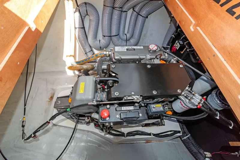 Slide: The Image of Engine compartment of a 2017 Lagoon 450 F catamaran, showcasing mechanical components and wiring. - 78