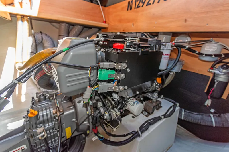 Slide: The Image of Engine compartment of a 2017 Lagoon 450 F catamaran, showcasing mechanical components and wiring. - 79