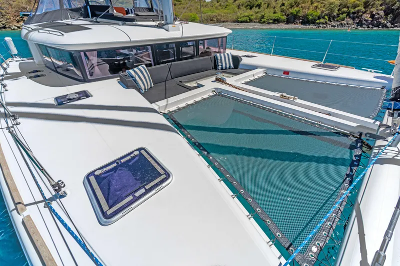 Slide: The Image of Lagoon 450 F catamaran deck with netting, 2017 model, anchored in turquoise waters. - 9