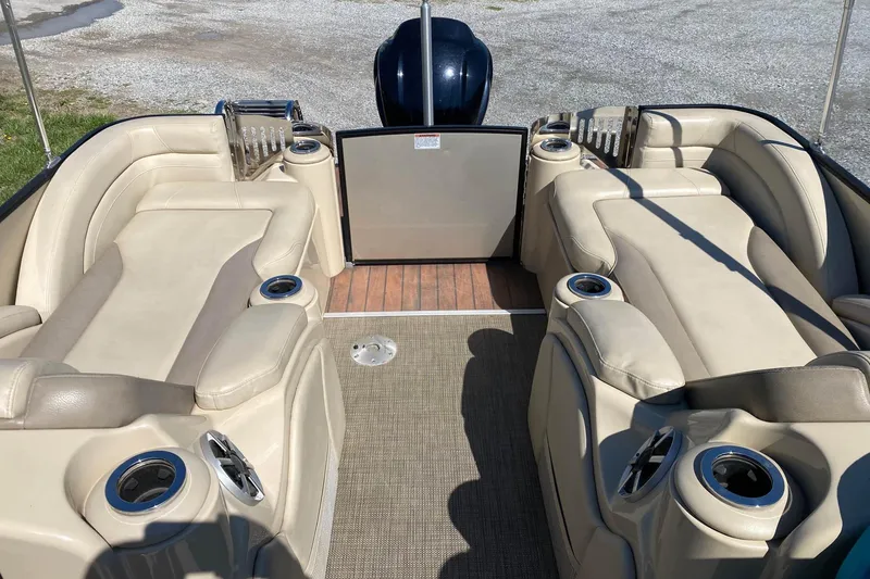 Slide: The Image of Luxurious interior of 2016 Starcraft MX 23 L pontoon boat with beige seating and cup holders. - 10