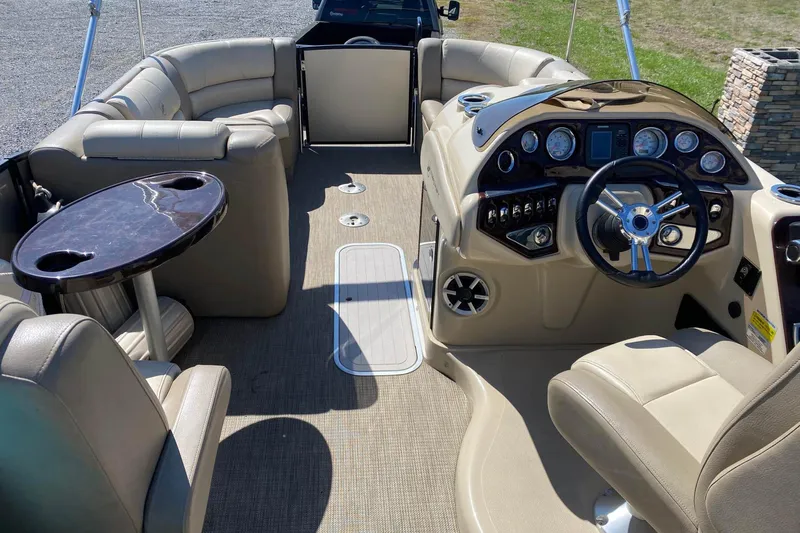 Slide: The Image of Interior of 2016 Starcraft MX 23 L pontoon boat with beige seating and modern dashboard. - 5