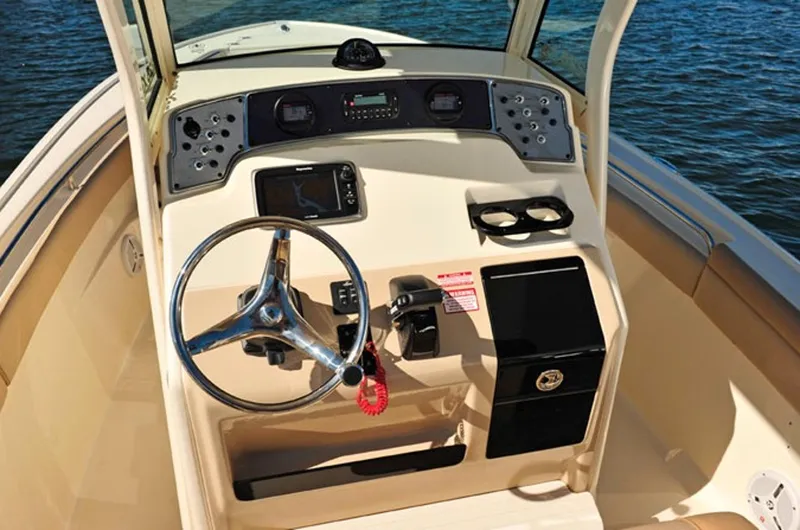 Slide: The Image of Manufacturer Provided Image: 2017 Scout 225 XSF boat dashboard with steering wheel and control panel. - 11