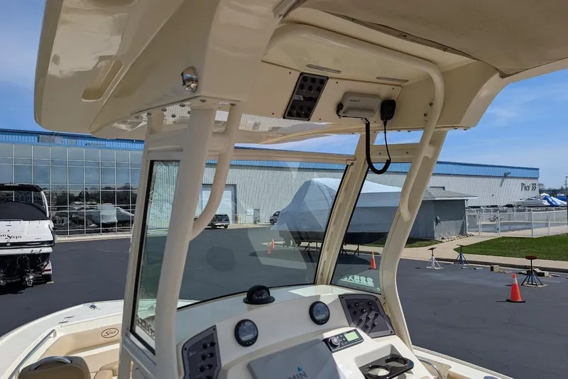 Slide: The Image of 2017 Scout 225 XSF boat interior with console and overhead view at marina. - 17