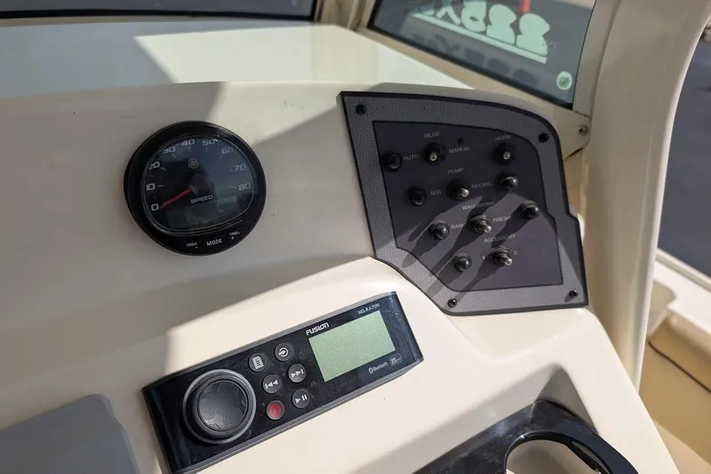 Slide: The Image of Control panel of a 2017 Scout 225 XSF boat with speedometer and audio system. - 20