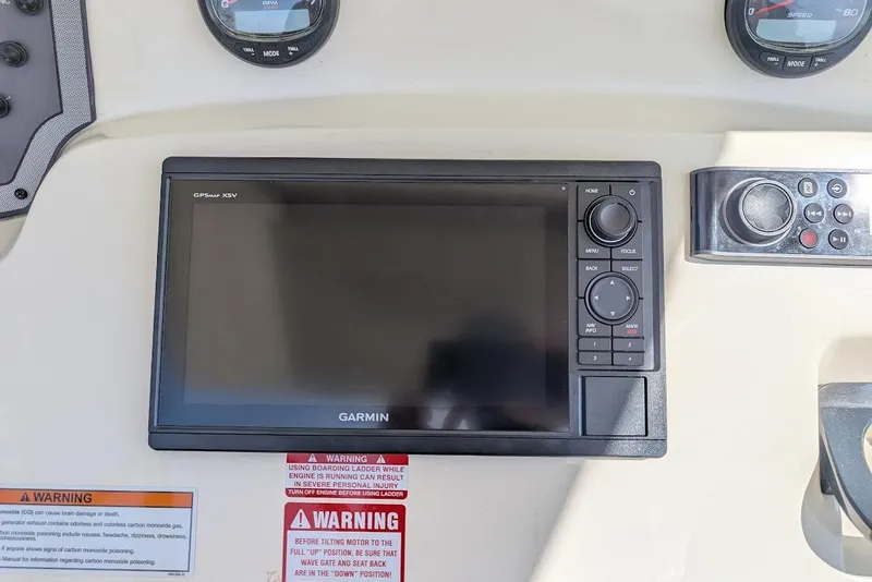 Slide: The Image of Garmin GPSmap XSV on 2017 Scout 225 XSF boat dashboard with warning labels. - 21