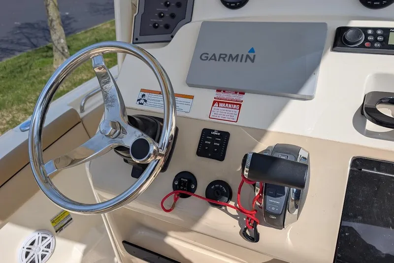 Slide: The Image of 2017 Scout 225 XSF boat dashboard with Garmin navigation system and steering wheel. - 22