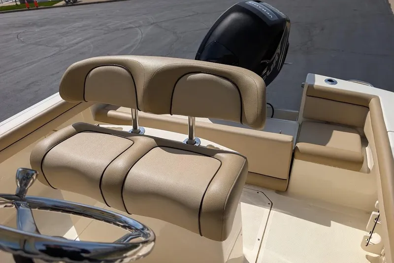 Slide: The Image of 2017 Scout 225 XSF boat interior with beige seating and steering wheel. - 23