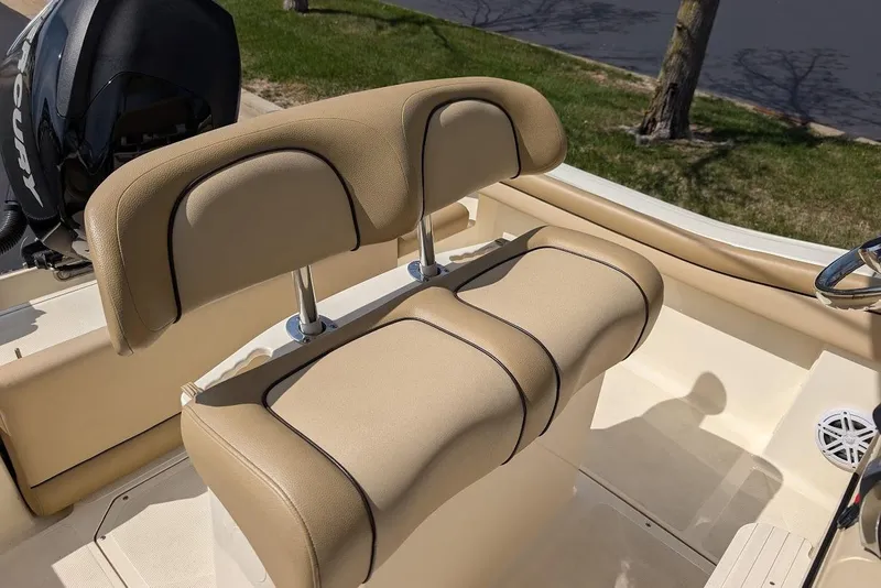 Slide: The Image of 2017 Scout 225 XSF boat with tan cushioned seating and Mercury engine. - 24