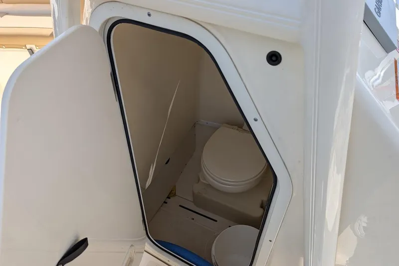 Slide: The Image of 2017 Scout 225 XSF boat interior showing compact marine toilet compartment. - 27