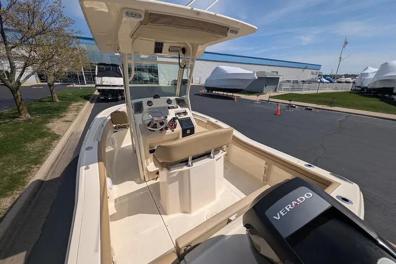 Slide: The Image of 2017 Scout 225 XSF boat with Verado engine, parked outdoors near a marina. - 29