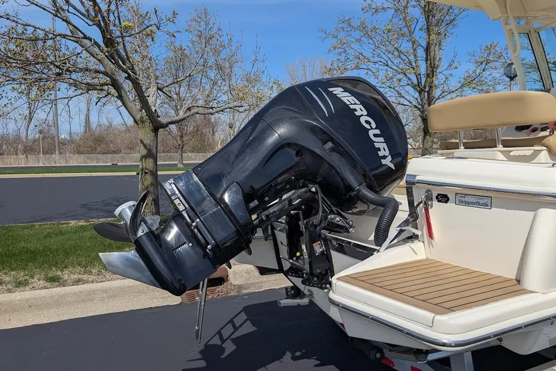 Slide: The Image of 2017 Scout 225 XSF boat with Mercury outboard motor, parked outdoors. - 30