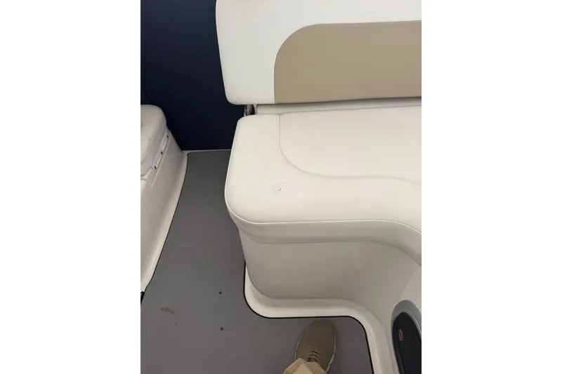 Slide: The Image of 2018 Robalo R305 Walkaround interior seating with beige and white upholstery. - 15