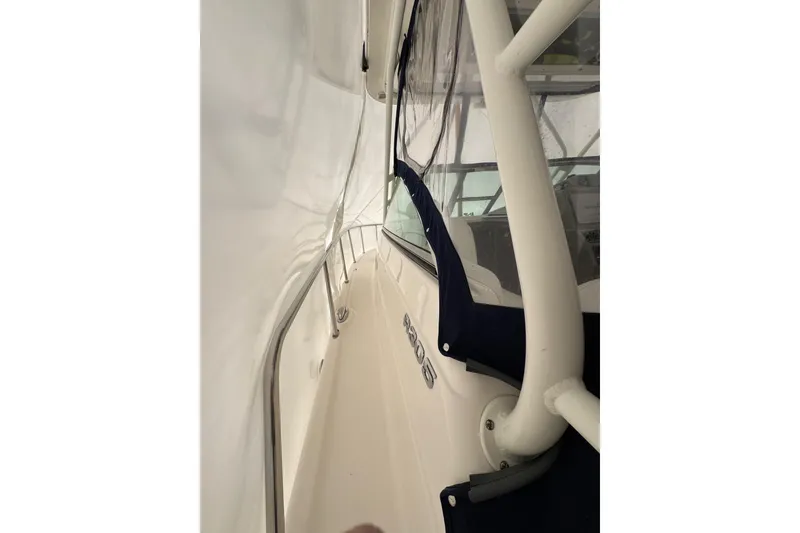 Slide: The Image of 2018 Robalo R305 Walkaround boat side view with railing and canopy details. - 17