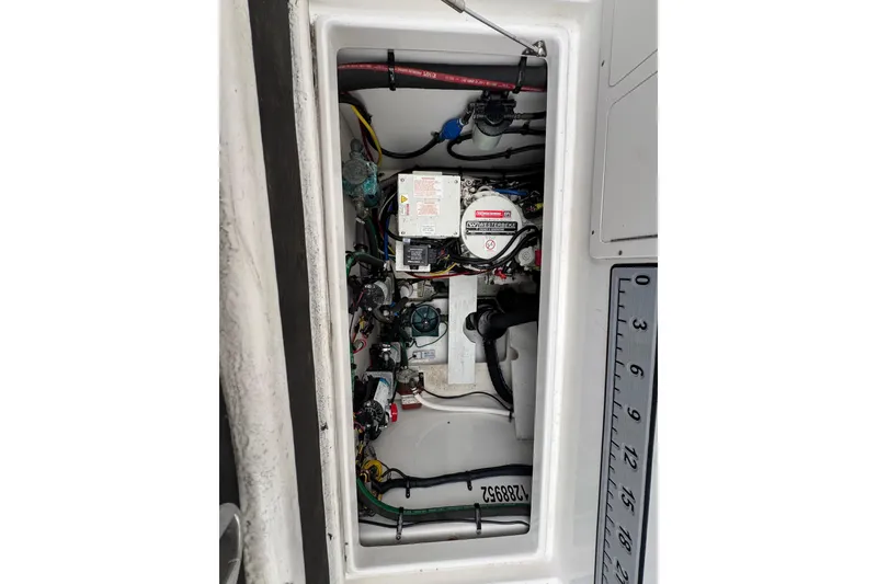Slide: The Image of Engine compartment of a 2018 Robalo R305 Walkaround boat, showcasing wiring and components. - 21