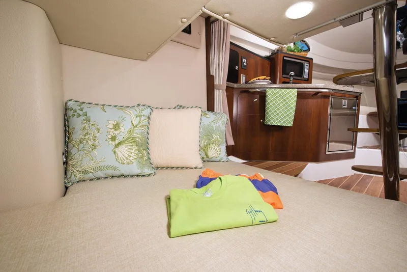 Slide: The Image of Manufacturer Provided Image: 2018 Robalo R305 Walkaround cabin interior with bed, pillows, and kitchenette. - 30