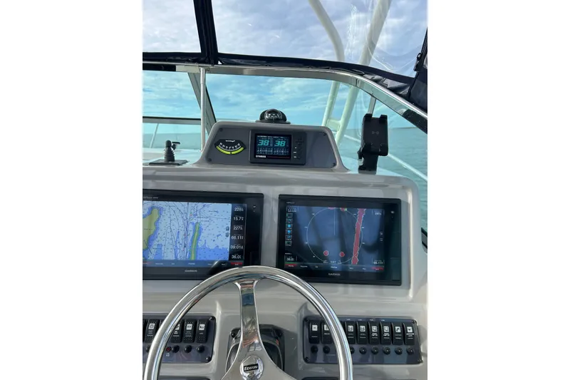 Slide: The Image of Helm of 2018 Robalo R305 Walkaround with navigation screens and steering wheel. - 4