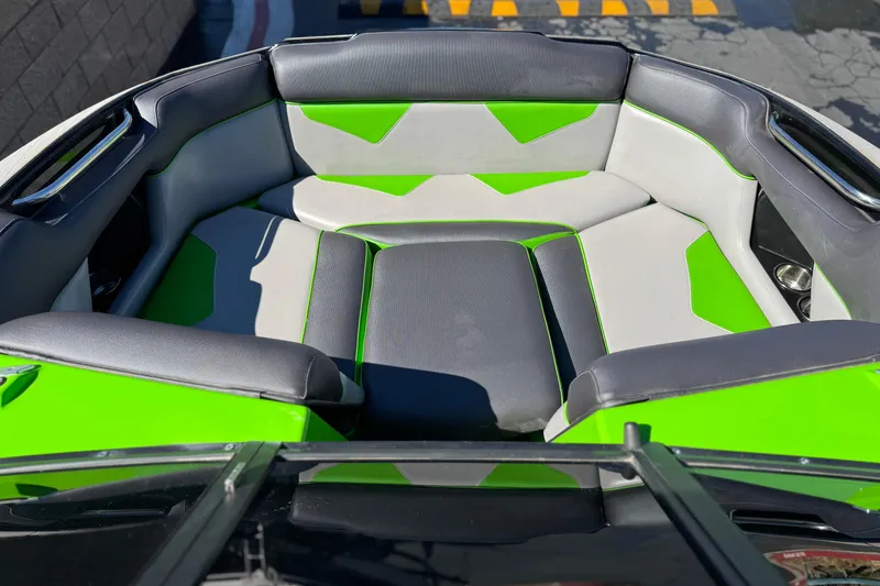 Slide: The Image of 2021 Moomba Kaiyen boat interior with green and gray seating. - 10