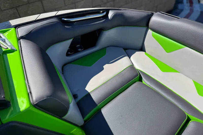 Slide: The Image of 2021 Moomba Kaiyen boat interior with green and gray seating. - 11