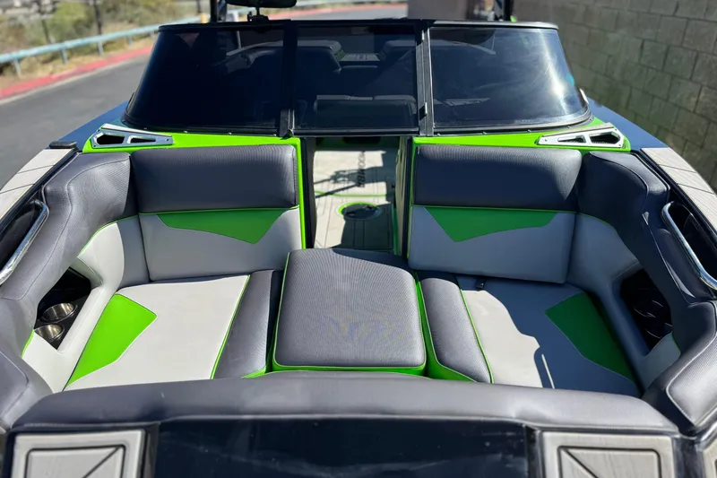 Slide: The Image of 2021 Moomba Kaiyen boat interior with gray and green seating, showcasing modern design. - 14