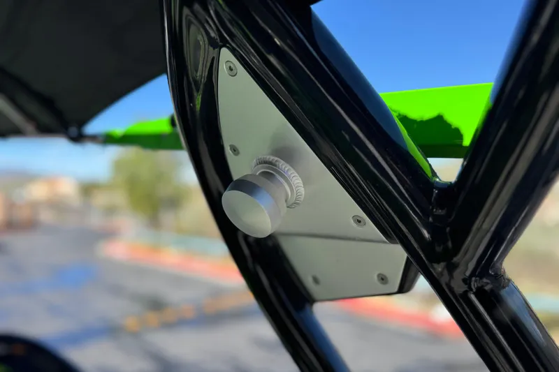 Slide: The Image of Close-up of a 2021 Moomba Kaiyen boat's metal component with green accents. - 18