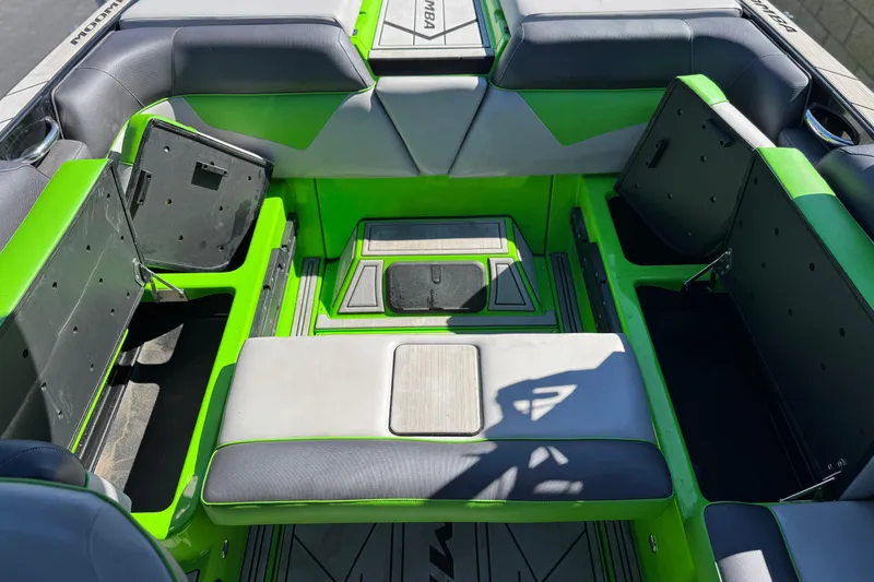 Slide: The Image of 2021 Moomba Kaiyen boat interior with vibrant green and gray seating. - 22