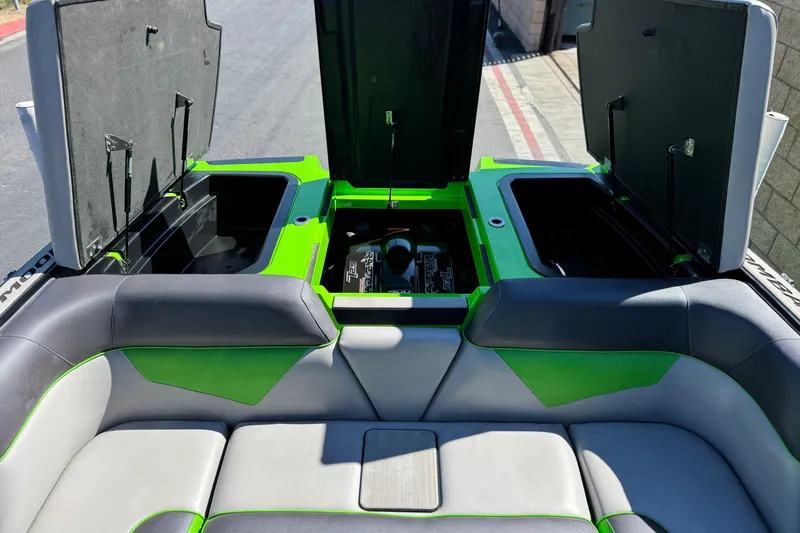 Slide: The Image of 2021 Moomba Kaiyen boat interior with open storage compartments and seating. - 23