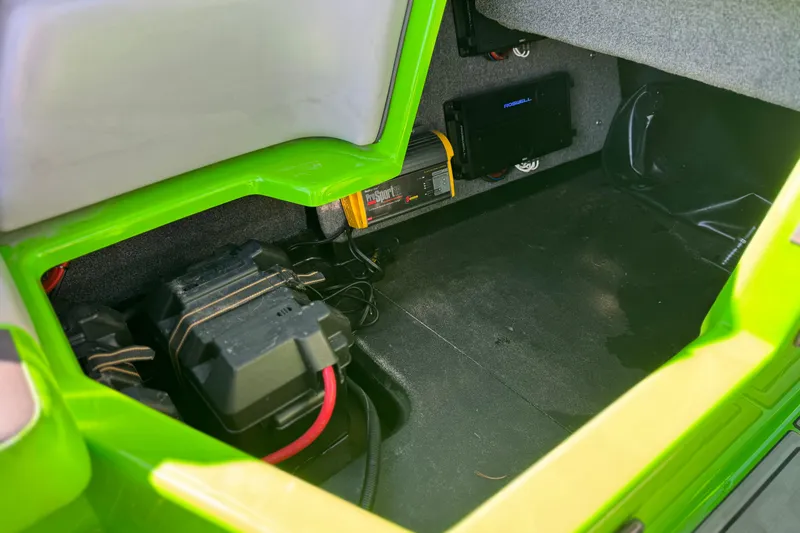 Slide: The Image of 2021 Moomba Kaiyen storage compartment with battery and electrical components. - 28