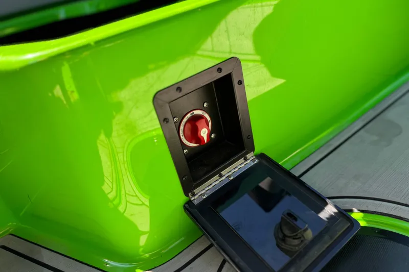 Slide: The Image of 2021 Moomba Kaiyen boat battery switch in vibrant green hull. - 29