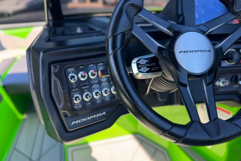 Slide: The Image of 2021 Moomba Kaiyen boat dashboard with steering wheel and control panel. - 33