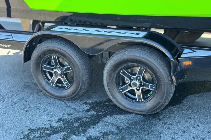 Slide: The Image of Trailer wheels of a 2021 Moomba Kaiyen boat on pavement. - 38