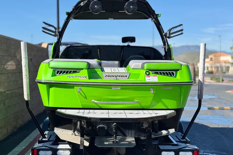 Slide: The Image of 2021 Moomba Kaiyen boat in vibrant green, rear view on trailer. - 4