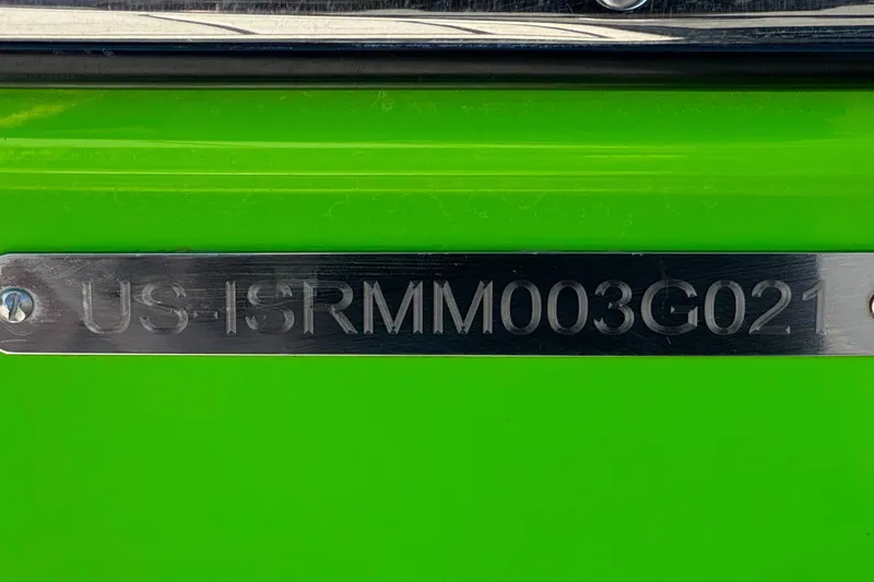 Slide: The Image of 2021 Moomba Kaiyen boat with hull identification number on bright green surface. - 41