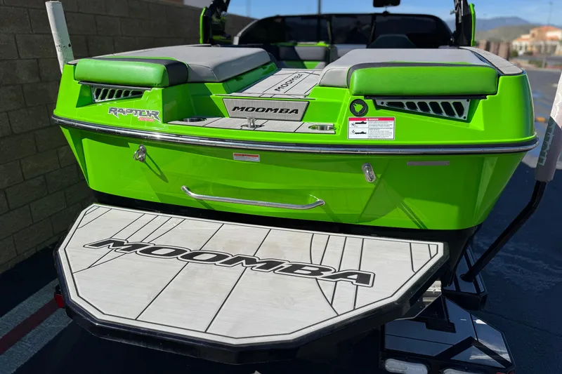 Slide: The Image of 2021 Moomba Kaiyen boat, vibrant green, rear view with swim platform. - 6