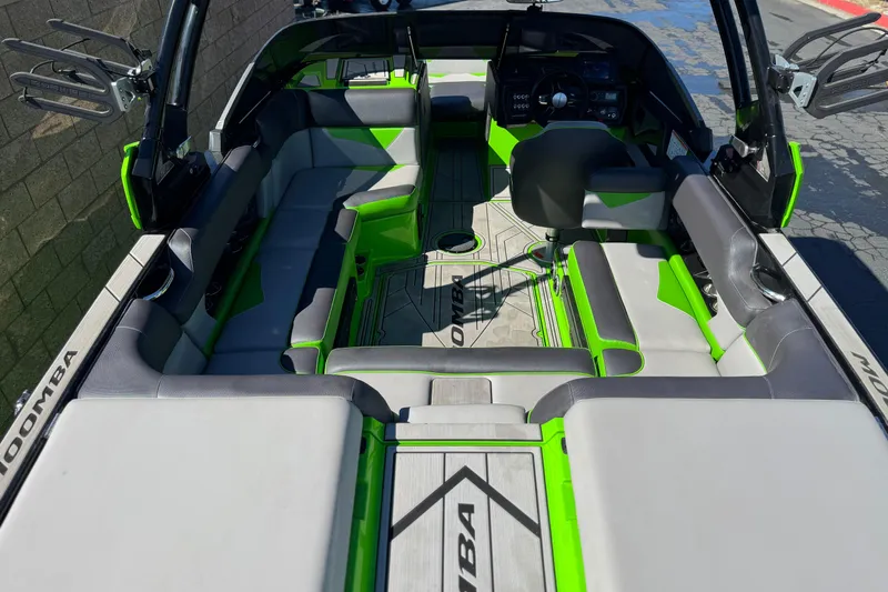 Slide: The Image of 2021 Moomba Kaiyen boat interior with green and gray seating, showcasing modern design. - 9