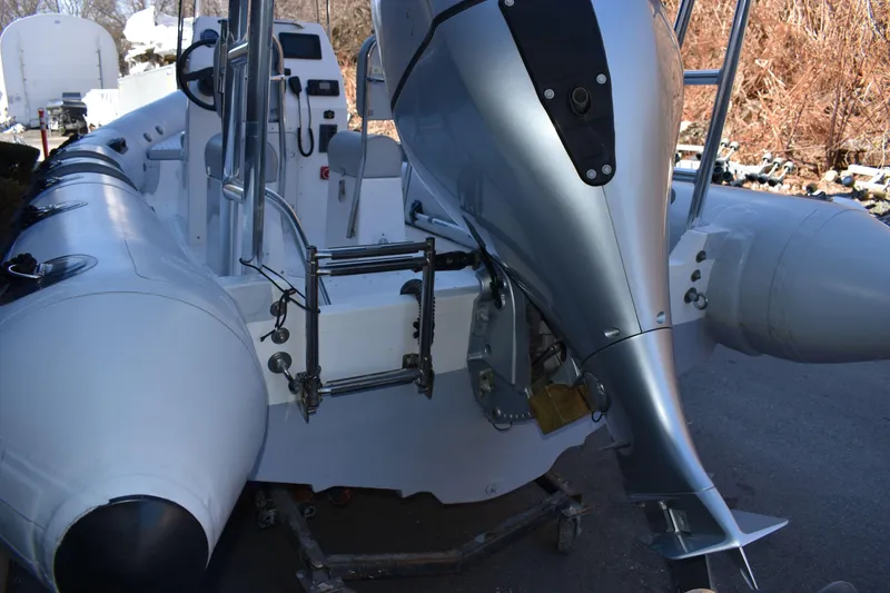 Slide: The Image of 2020 Ribcraft 5.85 inflatable boat with outboard motor, docked on a trailer. - 11