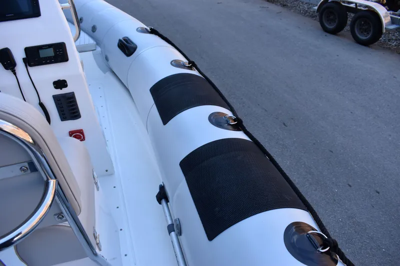 Slide: The Image of 2020 Ribcraft 5.85 boat interior with control panel and seating. - 12